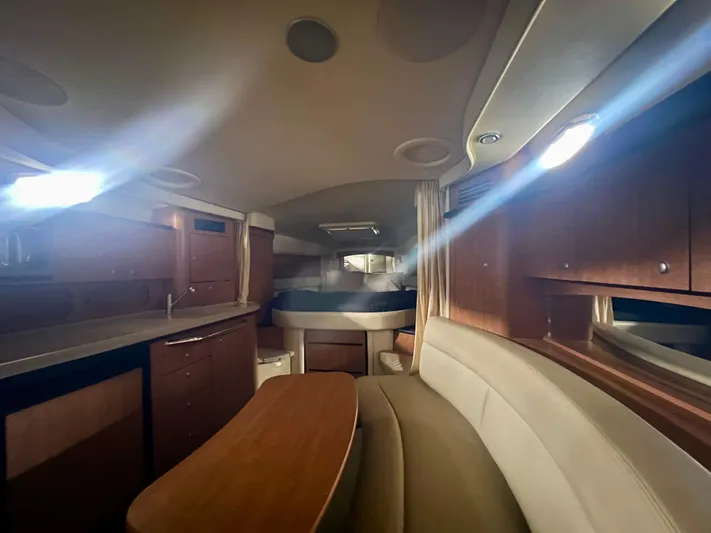  Yacht Photos Pics 2006 Sea Ray 340 Sundancer cabin interior with wood finishes and seating area.