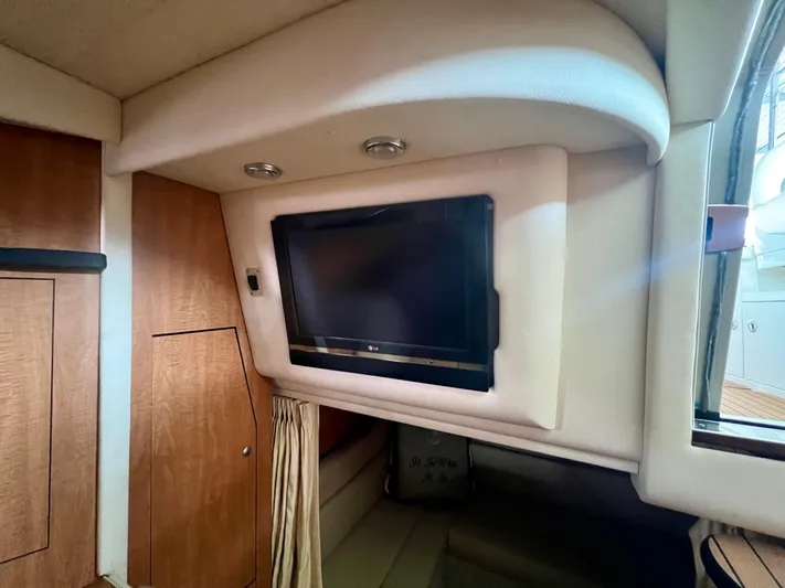  Yacht Photos Pics Interior of 2006 Sea Ray 340 Sundancer with wall-mounted TV and wood paneling.