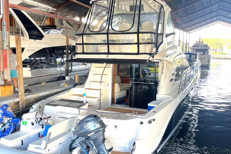  Yacht Photos Pics 2009 Sea Ray Sedan Bridge yacht docked in a marina, showcasing luxury design and spacious interior.