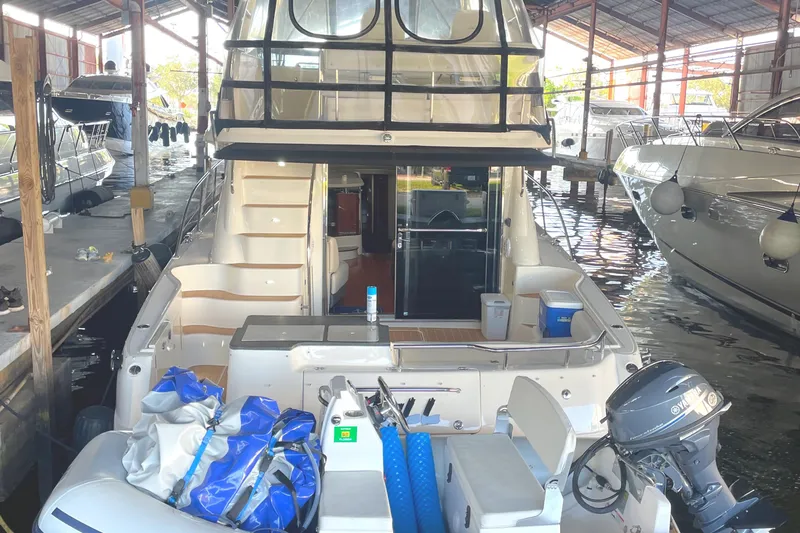  Yacht Photos Pics 2009 Sea Ray Sedan Bridge yacht docked in a marina, rear view with equipment on deck.