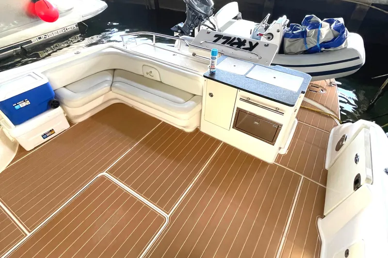  Yacht Photos Pics 2009 Sea Ray Sedan Bridge boat deck with seating, kitchenette, and storage.