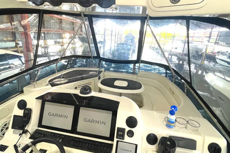  Yacht Photos Pics 2009 Sea Ray Sedan Bridge cockpit with Garmin displays and spacious seating.