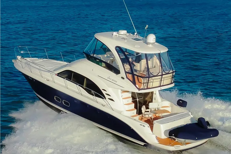  Yacht Photos Pics 2009 Sea Ray Sedan Bridge yacht cruising on open blue water.