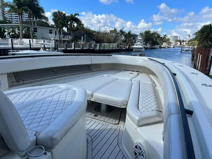  Yacht Photos Pics 2017 Hydra-Sports 4200 Siesta boat with luxurious seating, docked in a scenic waterfront area.