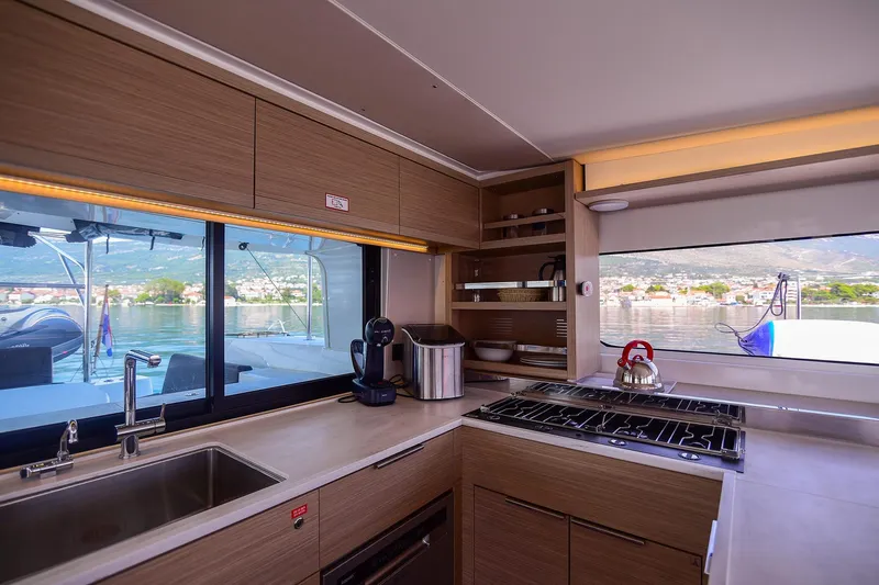  Yacht Photos Pics Modern kitchen interior of 2024 Lagoon 450 F yacht with scenic window view.