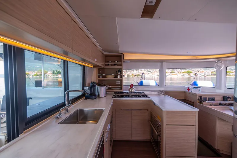  Yacht Photos Pics Modern kitchen interior of 2024 Lagoon 450 F yacht with sleek design and ample natural light.