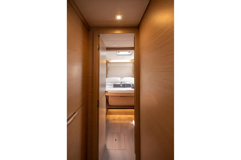  Yacht Photos Pics Luxurious interior cabin of 2024 Lagoon 450 F catamaran, featuring modern wood finishes.