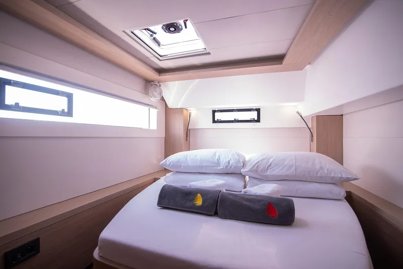  Yacht Photos Pics Luxurious cabin interior of 2024 Lagoon 450 F yacht with cozy bedding.