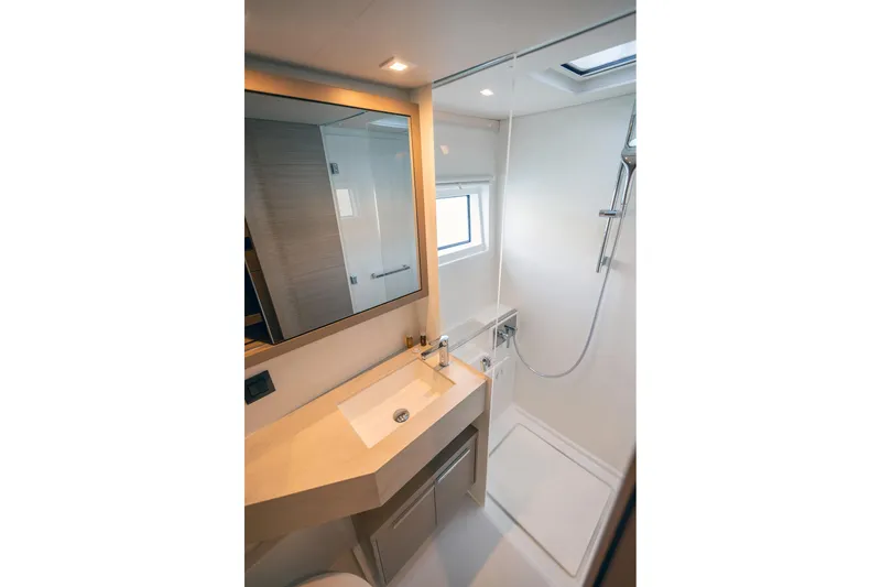  Yacht Photos Pics Luxurious bathroom in 2024 Lagoon 450 F yacht with modern fixtures and spacious shower.
