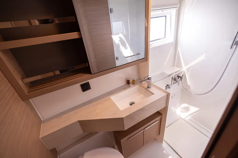  Yacht Photos Pics Modern bathroom in 2024 Lagoon 450 F yacht, featuring sleek design and natural lighting.