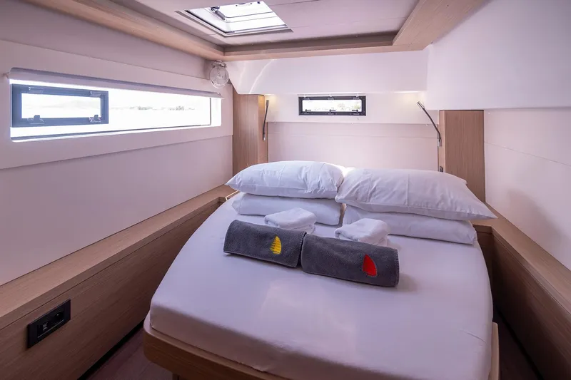  Yacht Photos Pics Luxurious cabin interior of 2024 Lagoon 450 F yacht with cozy bed and modern design.