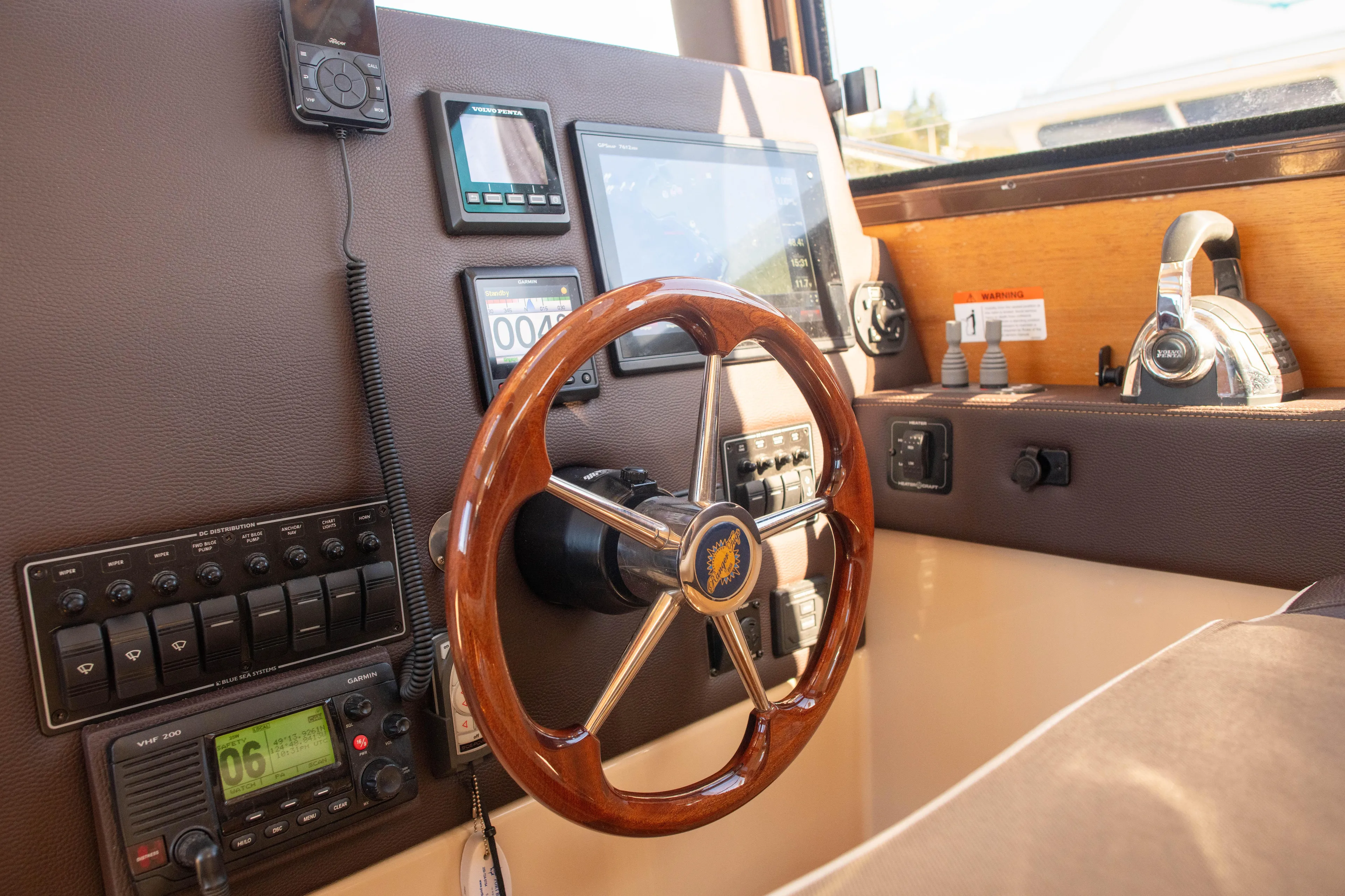 Yacht Photos Pics 2016 Ranger Tugs R-29 helm with wooden steering wheel and navigation instruments.