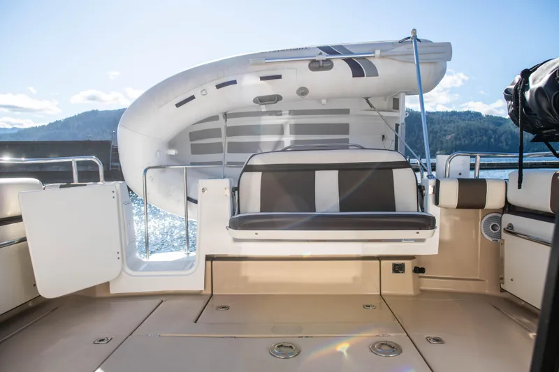  Yacht Photos Pics 2016 Ranger Tugs R-29 boat deck with seating and mounted dinghy, scenic water view.