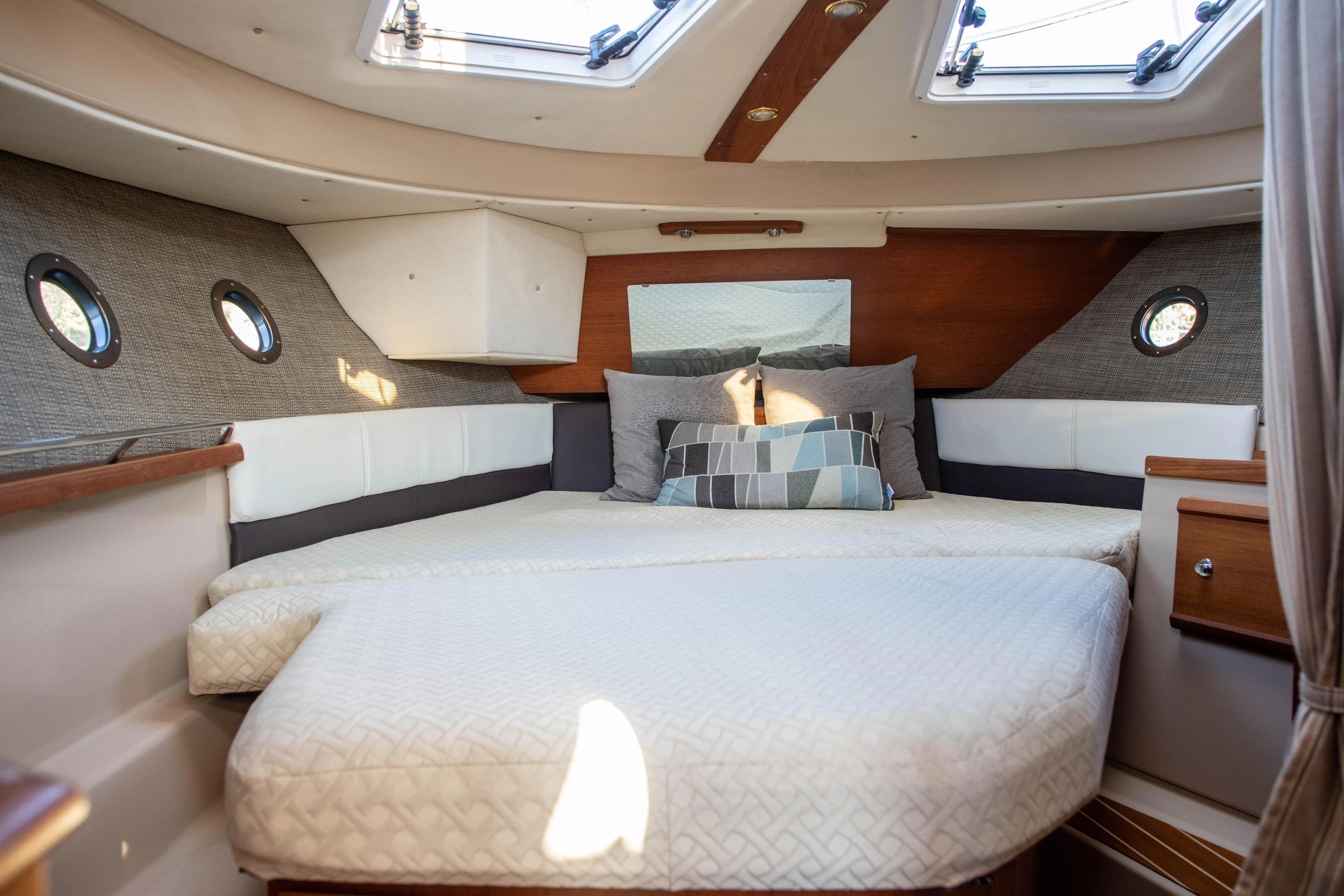  Yacht Photos Pics Cozy interior cabin of 2016 Ranger Tugs R-29 with skylights and plush bedding.