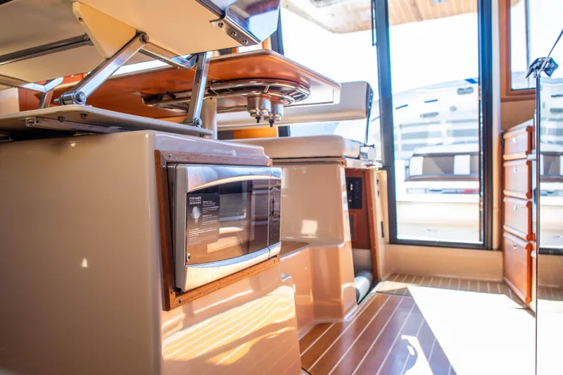  Yacht Photos Pics Interior of 2016 Ranger Tugs R-29 boat, featuring modern kitchen appliances and seating.
