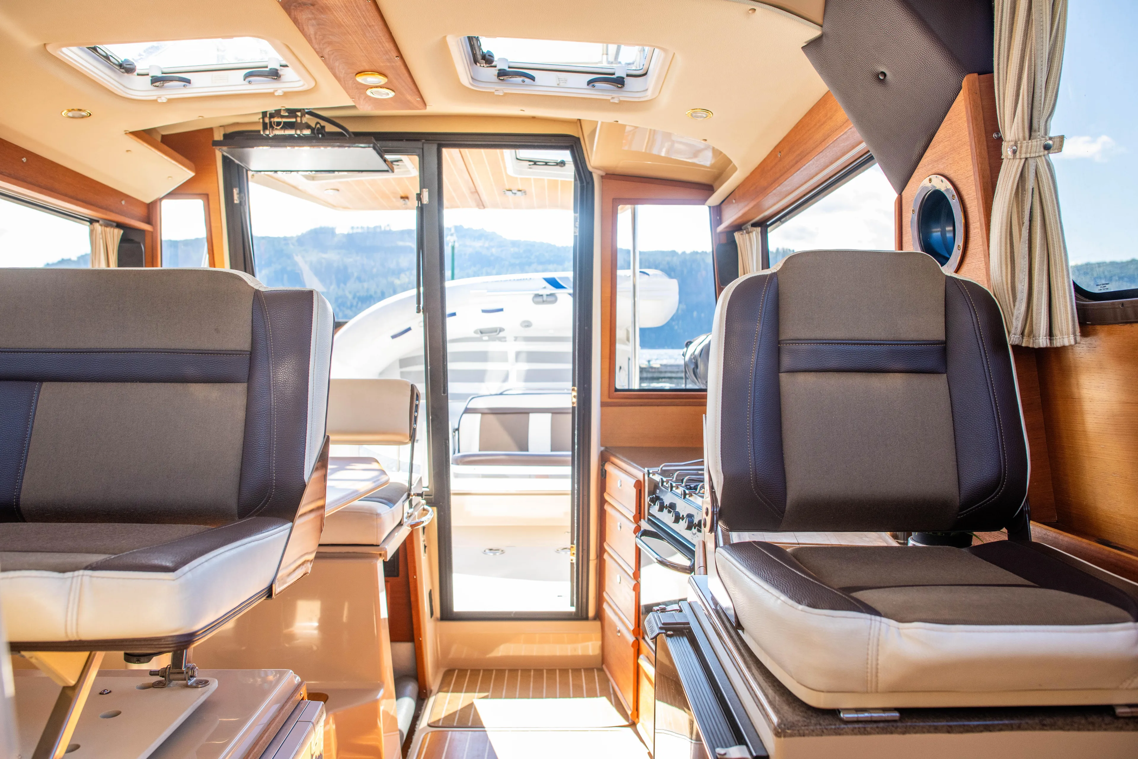  Yacht Photos Pics Interior of 2016 Ranger Tugs R-29 boat, featuring seating and natural light.
