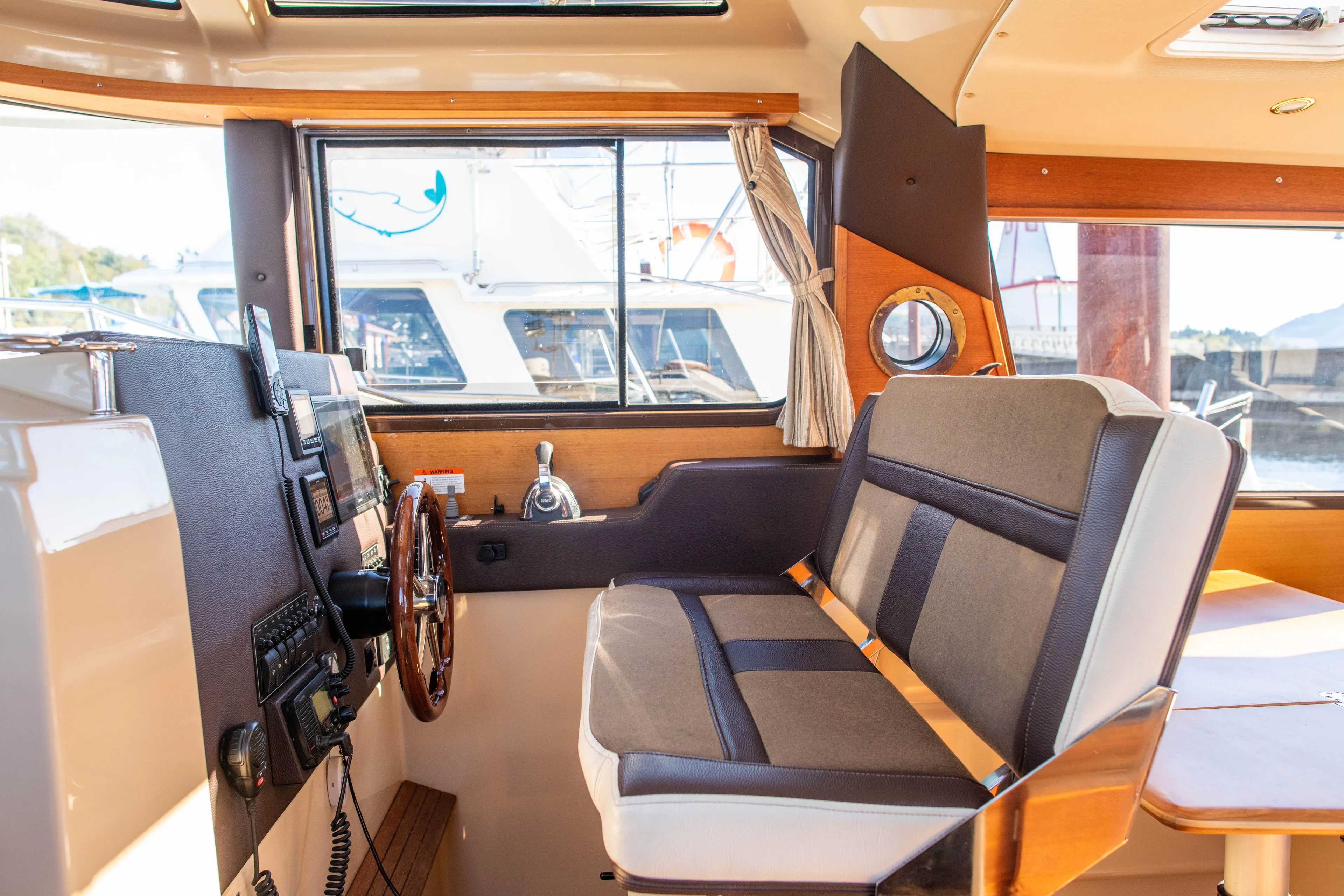  Yacht Photos Pics Interior of 2016 Ranger Tugs R-29 boat, featuring helm station and seating area.