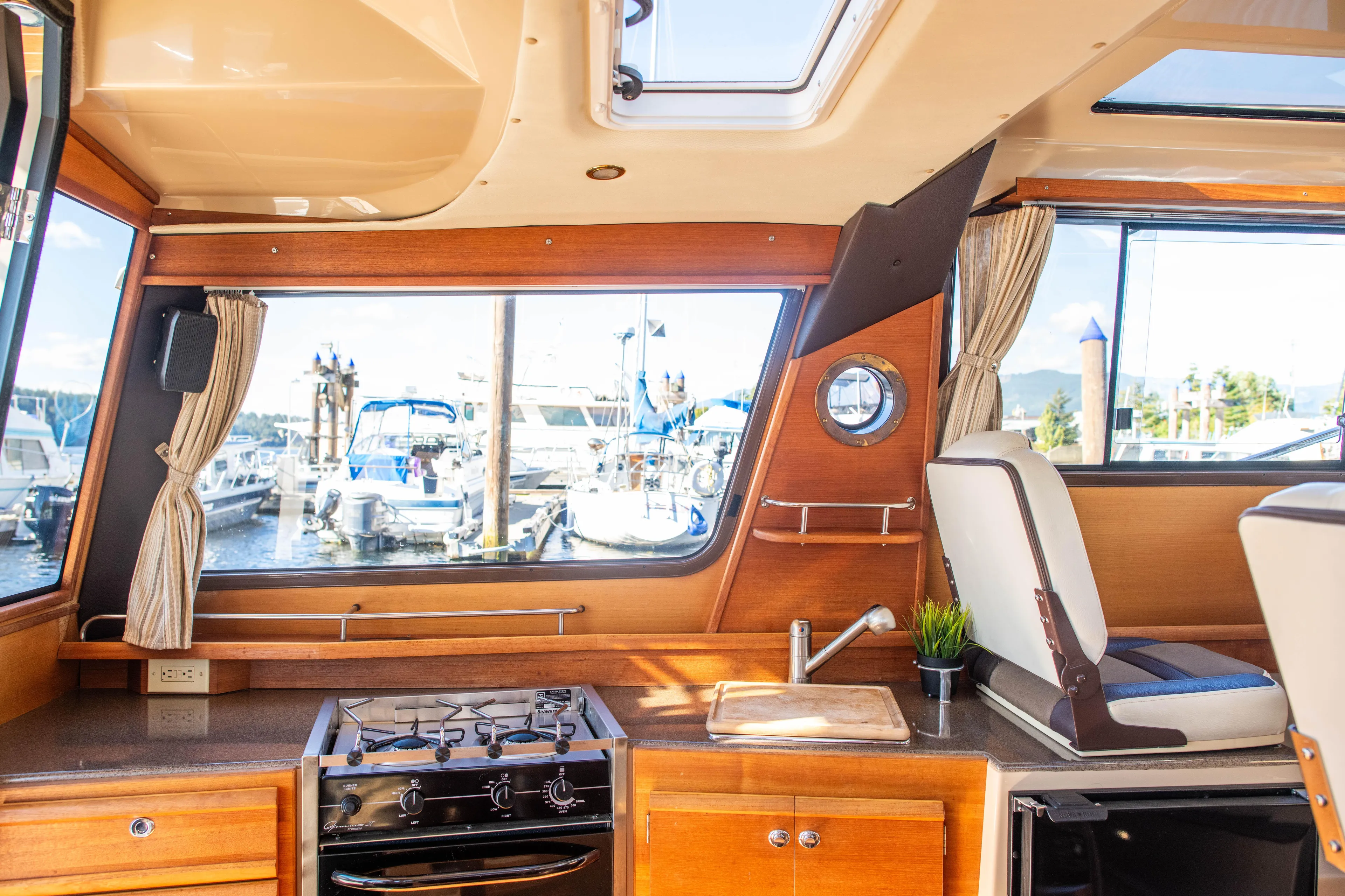  Yacht Photos Pics Interior of 2016 Ranger Tugs R-29 boat with kitchen and seating area.