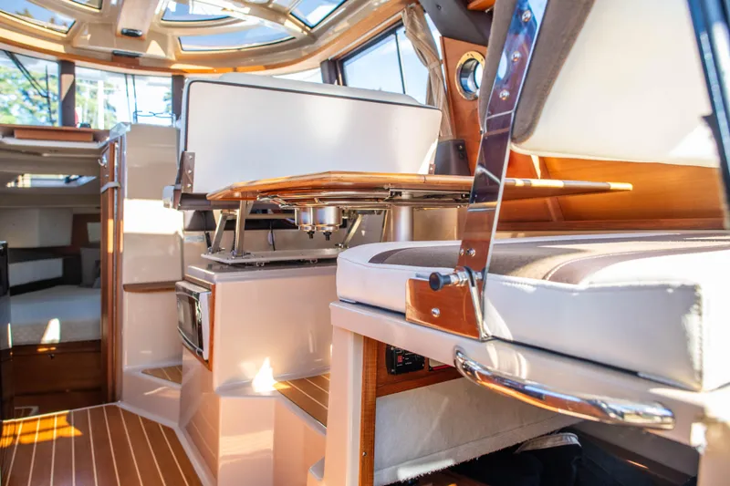  Yacht Photos Pics Interior of 2016 Ranger Tugs R-29 boat, featuring elegant wood finishes and modern seating.