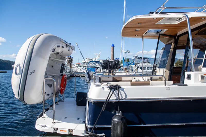  Yacht Photos Pics 2016 Ranger Tugs R-29 boat docked with inflatable dinghy, clear blue sky background.
