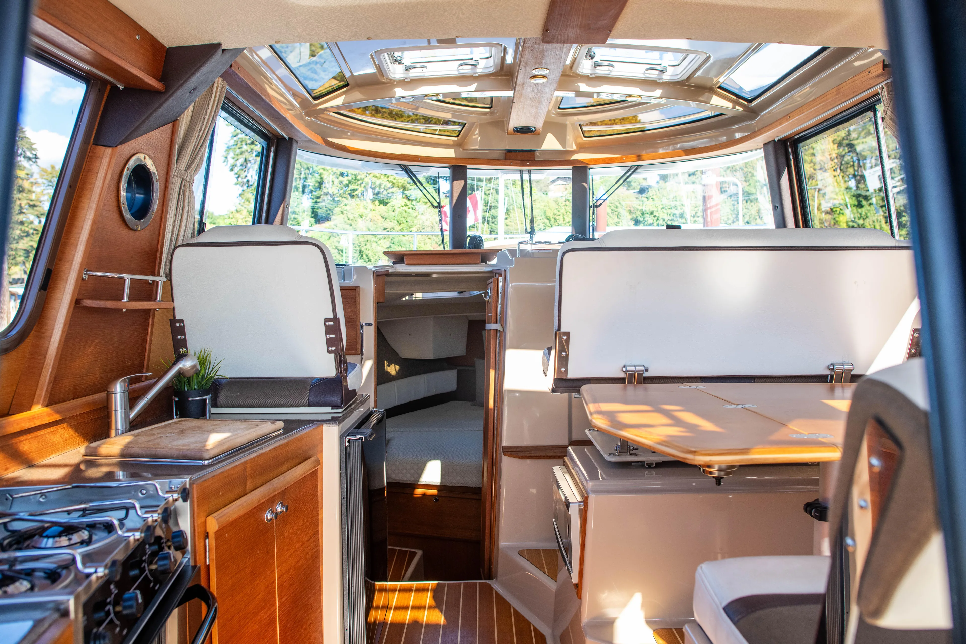  Yacht Photos Pics Interior of 2016 Ranger Tugs R-29 boat with wood finishes and panoramic windows.