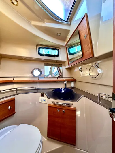  Yacht Photos Pics 2016 Ranger Tugs R-29 bathroom with modern fixtures, wooden cabinetry, and a sleek design.