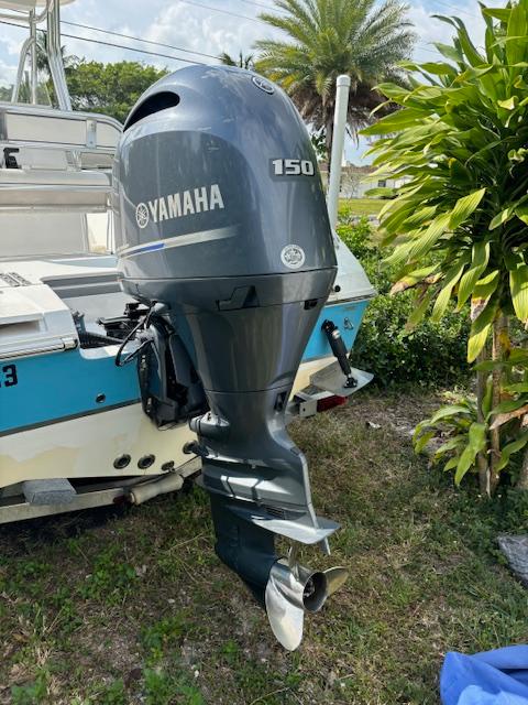 2016 Release 208 RX boat with Yamaha 150 outboard motor, parked outdoors.