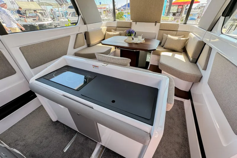  Yacht Photos Pics Luxurious interior of 2024 Axopar 45 XC Cross Cabin with modern seating and kitchenette.