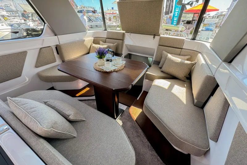  Yacht Photos Pics Luxurious interior of 2024 Axopar 45 XC Cross Cabin with plush seating and elegant table.
