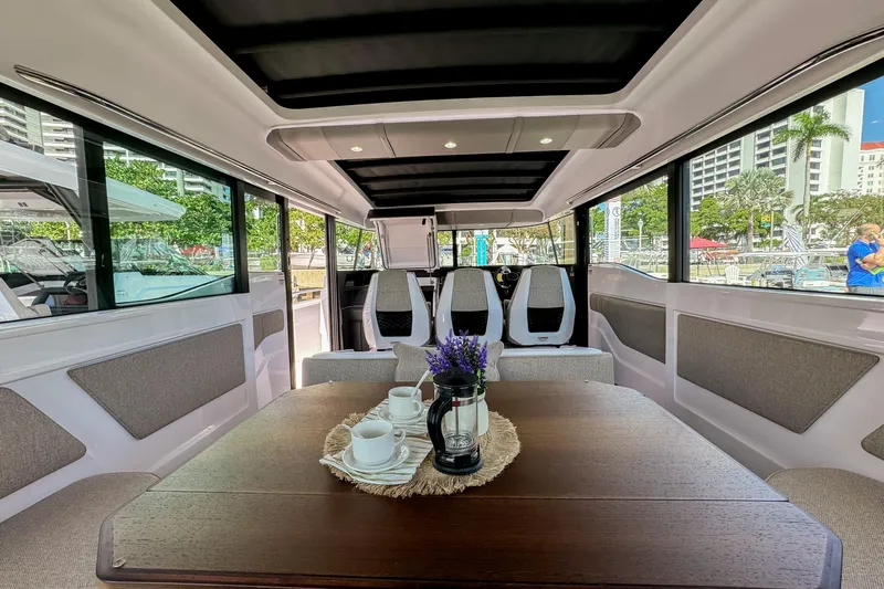 Yacht Photos Pics Interior of 2024 Axopar 45 XC Cross Cabin with elegant seating and table setup.