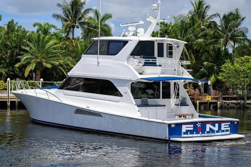 Fine Expierence Yacht Photos Pics 2001 Viking 65 Enclosed Bridge yacht docked near tropical palm trees.