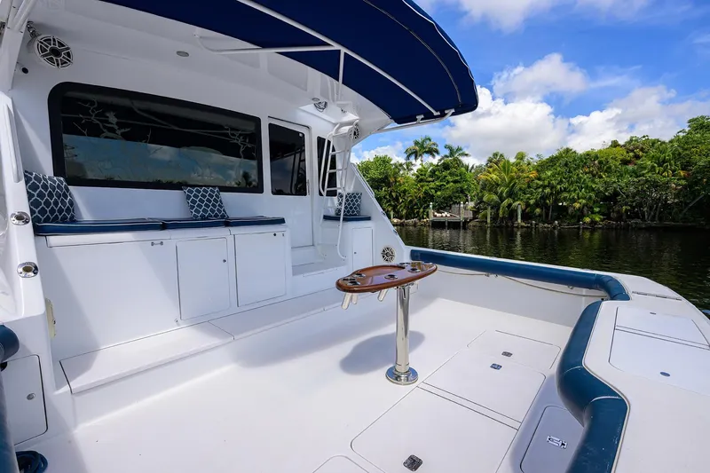 Fine Expierence Yacht Photos Pics 2001 Viking 65 Enclosed Bridge yacht deck with seating, table, and scenic water view.