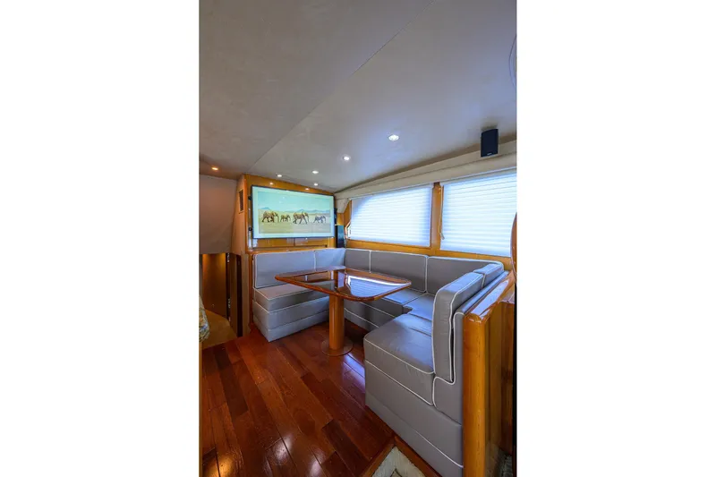 Fine Expierence Yacht Photos Pics Luxurious interior of 2001 Viking 65 Enclosed Bridge yacht with elegant seating and wooden flooring.