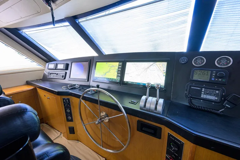 Fine Expierence Yacht Photos Pics 2001 Viking 65 Enclosed Bridge helm with navigation screens and controls.
