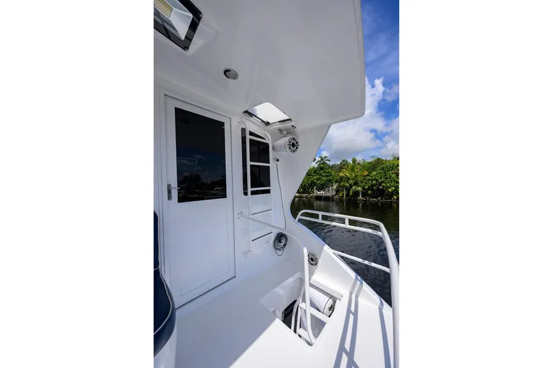 Fine Expierence Yacht Photos Pics 2001 Viking 65 Enclosed Bridge yacht deck with white exterior and water view.