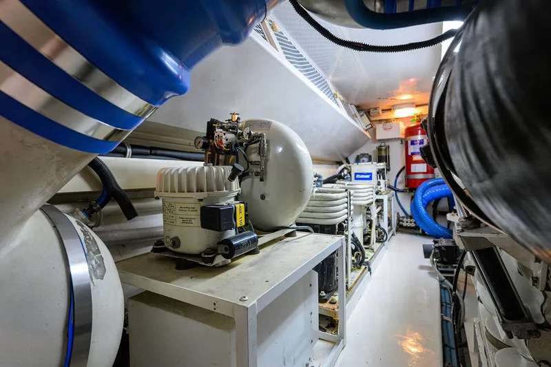 Fine Expierence Yacht Photos Pics Engine room of 2001 Viking 65 Enclosed Bridge yacht, featuring mechanical equipment and piping.