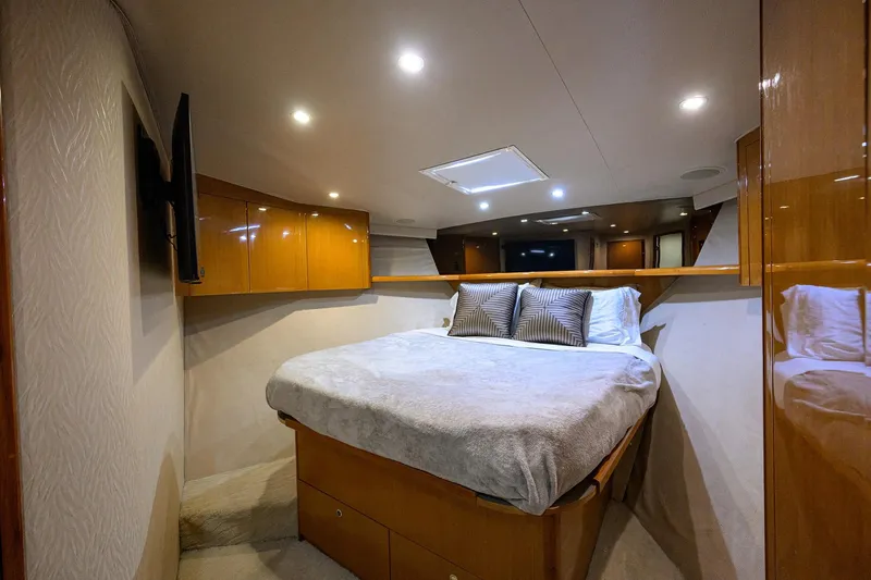 Fine Expierence Yacht Photos Pics Luxurious bedroom interior of 2001 Viking 65 Enclosed Bridge yacht with modern lighting.