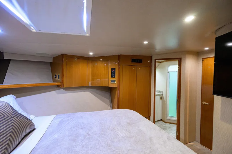 Fine Expierence Yacht Photos Pics Luxurious bedroom interior of 2001 Viking 65 Enclosed Bridge yacht with modern amenities.