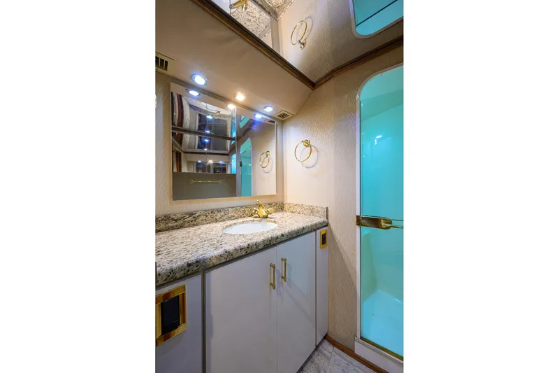 Fine Expierence Yacht Photos Pics Luxurious bathroom in 2001 Viking 65 Enclosed Bridge yacht with granite countertop and shower.