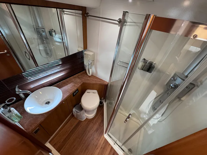  Yacht Photos Pics Luxurious bathroom in 2008 Sunseeker Manhattan 70 yacht with modern fixtures and glass shower.