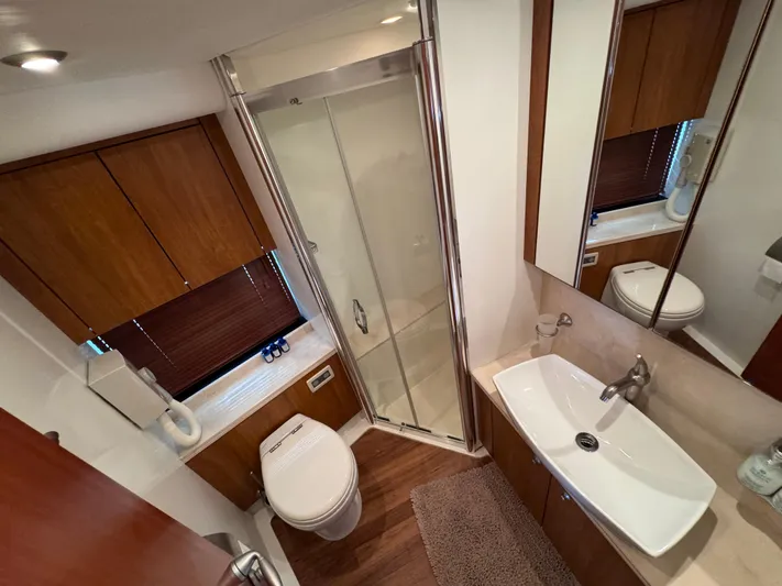  Yacht Photos Pics Luxurious bathroom in 2008 Sunseeker Manhattan 70 yacht with modern fixtures and wood accents.