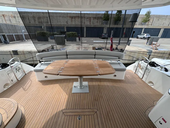  Yacht Photos Pics Luxurious 2008 Sunseeker Manhattan 70 yacht deck with elegant seating and wooden table.