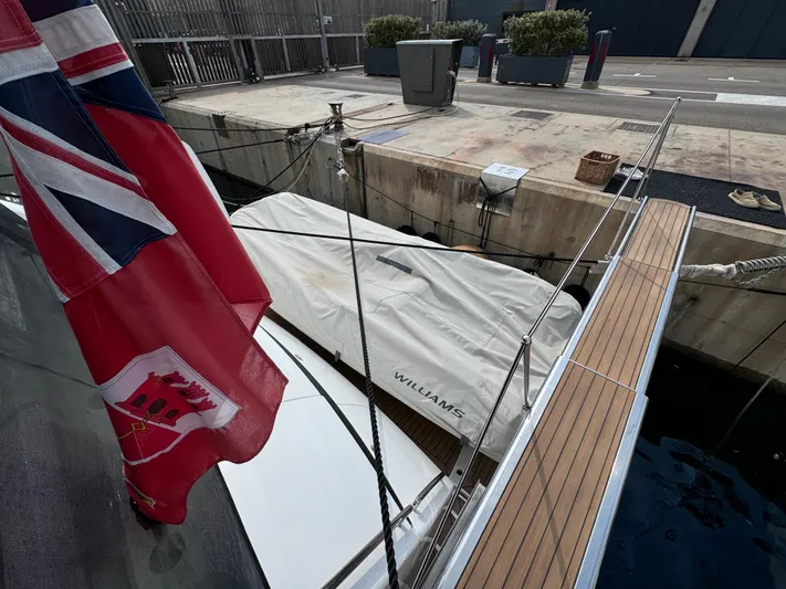  Yacht Photos Pics 2008 Sunseeker Manhattan 70 yacht docked, featuring a covered Williams tender and a flag.