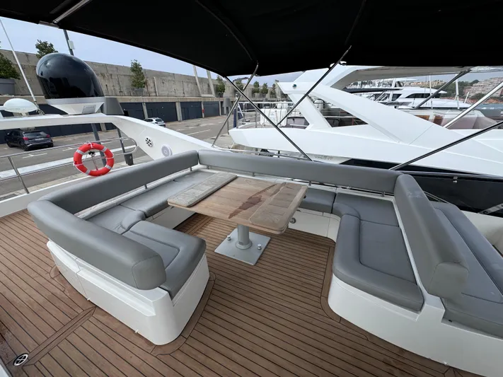  Yacht Photos Pics Luxurious 2008 Sunseeker Manhattan 70 yacht with spacious outdoor seating and wooden deck.