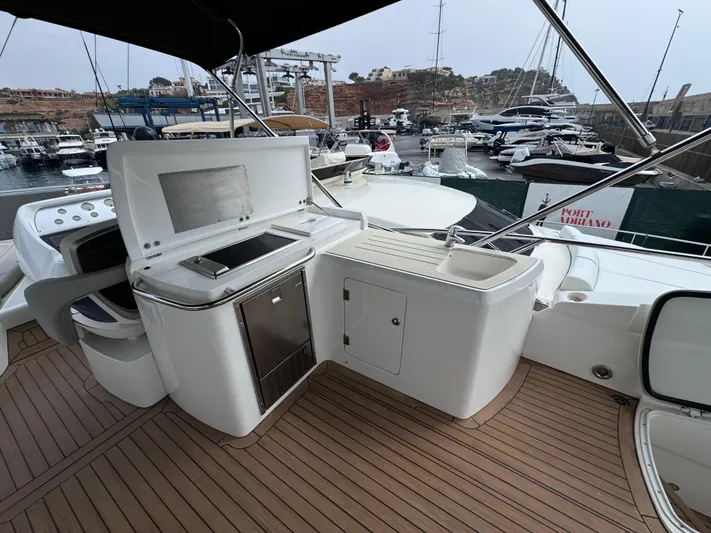  Yacht Photos Pics Luxury Sunseeker Manhattan 70 yacht deck with outdoor kitchen, 2008 model, docked at marina.
