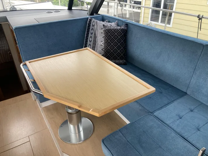  Yacht Photos Pics Luxurious interior of 2022 Moody Decksaloon 41 with blue seating and wooden table.