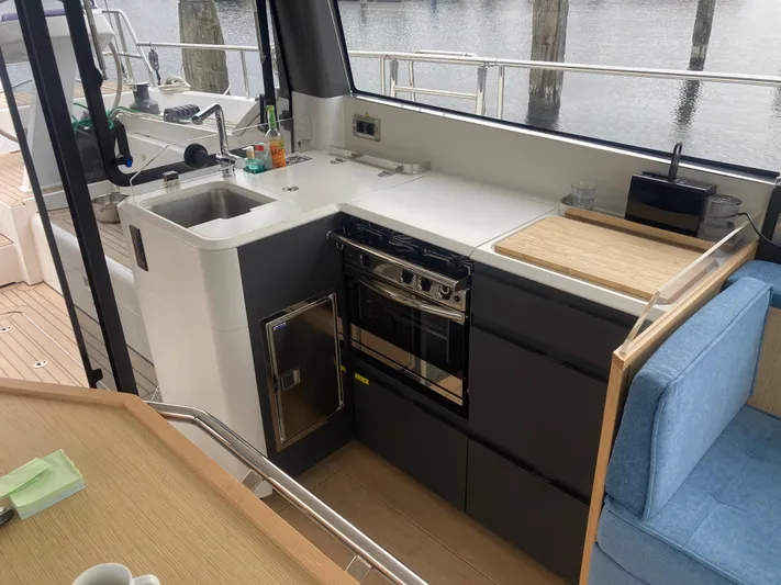  Yacht Photos Pics Modern kitchen area on a 2022 Moody Decksaloon 41 yacht, featuring sleek appliances and cabinetry.