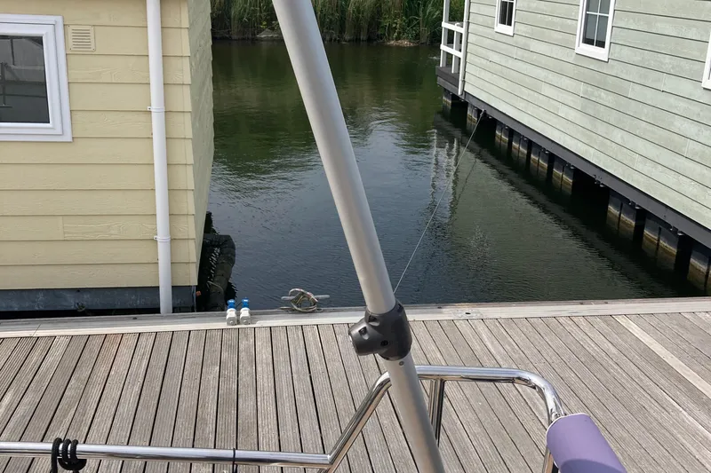  Yacht Photos Pics Moody Decksaloon 41, 2022, docked near waterfront houses, wooden deck visible.
