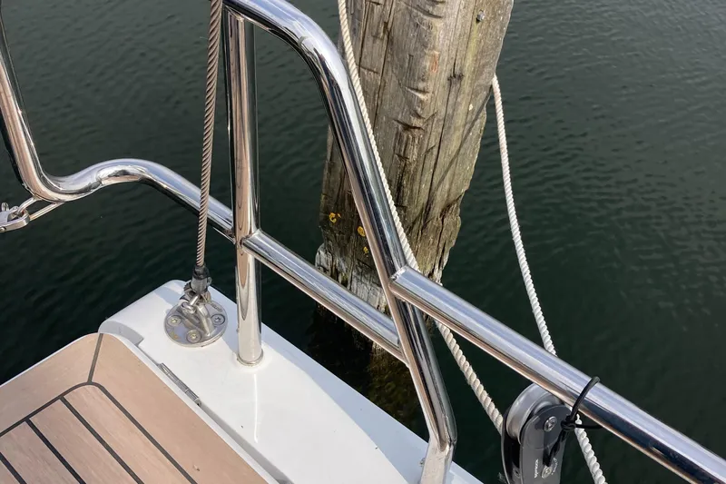  Yacht Photos Pics Stainless steel railing on a 2022 Moody Decksaloon 41 yacht, docked by a wooden post.