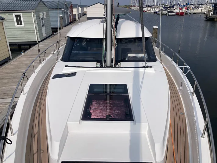  Yacht Photos Pics 2022 Moody Decksaloon 41 yacht docked at a marina, showcasing sleek design and spacious deck.